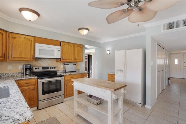 2231 E Peters Colony Rd, Carrollton, TX 75007 - kitchen with white appliances, light tile patterned flooring, backsplash, ornamental molding, and ceiling fan