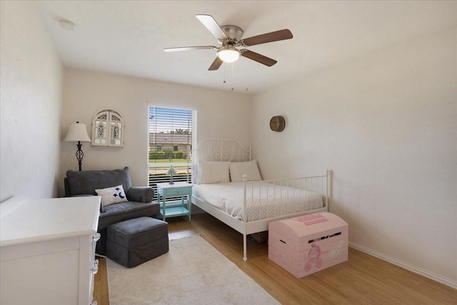 2231 E Peters Colony Rd, Carrollton, TX 75007 - bedroom featuring wood finished floors, ceiling fan, and baseboards