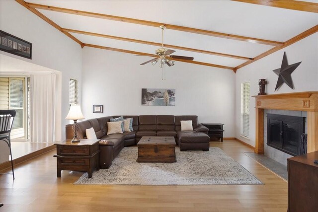 2231 E Peters Colony Rd, Carrollton, TX 75007 - living room with wood finished floors, a ceiling fan, and a fireplace with flush hearth
