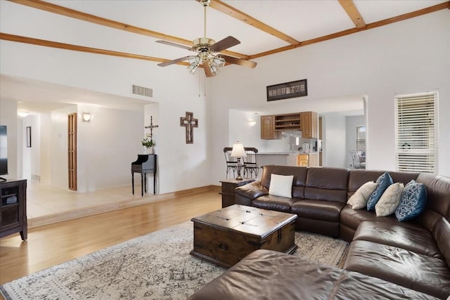 2231 E Peters Colony Rd, Carrollton, TX 75007 - living room featuring a ceiling fan, light wood-style floors, high vaulted ceiling, beamed ceiling, and baseboards