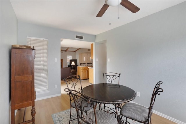 2231 E Peters Colony Rd, Carrollton, TX 75007 - dining room with a ceiling fan, light wood finished floors, and baseboards