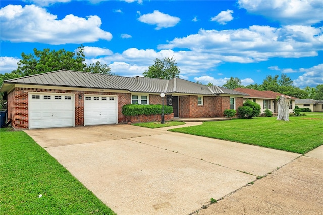 ranch-style house with an attached garage, a front lawn, brick siding, driveway, and metal roof