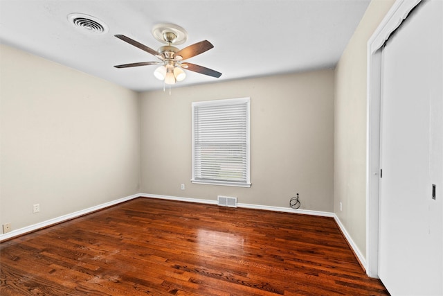 unfurnished bedroom with visible vents, wood finished floors, and a closet