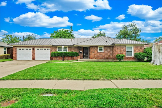 ranch-style house with concrete driveway, brick siding, a front yard, and a garage