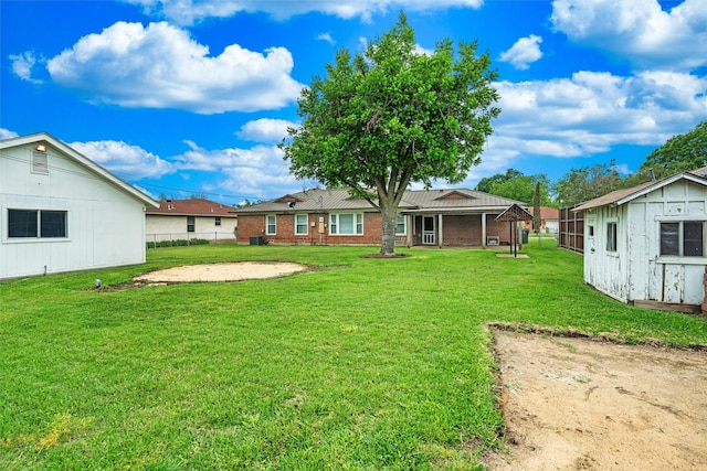 view of yard featuring an outdoor structure and fence