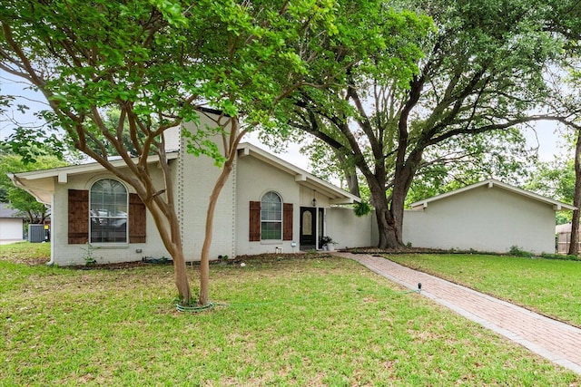 view of front of home with central AC and a front lawn