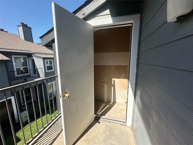 view of exterior entry with a balcony