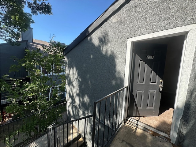 view of exterior entry featuring stucco siding