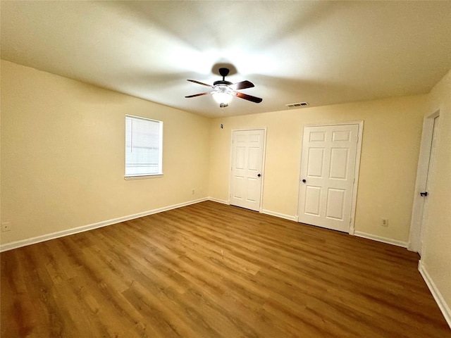 520 Lakeside Dr, Rockwall, TX 75032 - unfurnished bedroom with visible vents, a ceiling fan, baseboards, and wood finished floors