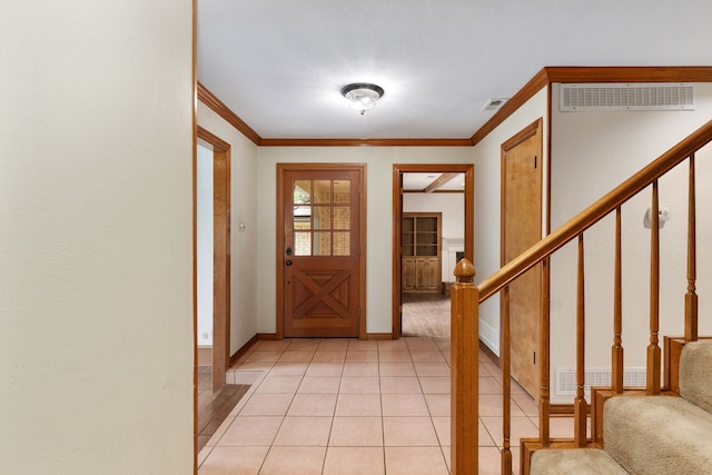 entrance foyer featuring stairs, crown molding, visible vents, and baseboards