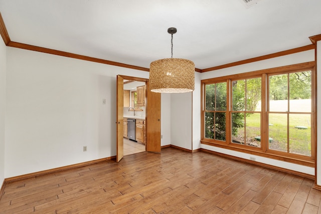 unfurnished dining area featuring crown molding, an inviting chandelier, a sink, light wood-style flooring, and baseboards
