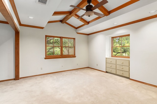 spare room featuring light colored carpet, lofted ceiling with beams, visible vents, and plenty of natural light