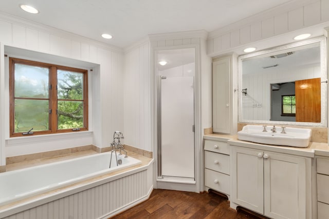 bathroom with crown molding, a shower stall, wood finished floors, and a bath