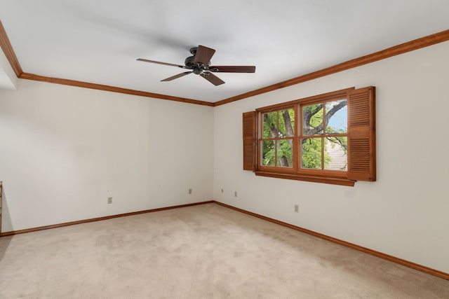 empty room with baseboards, ornamental molding, and light carpet