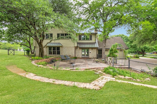 back of property with a yard, fence, french doors, and a patio area