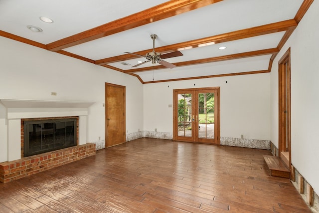 unfurnished living room featuring a brick fireplace, a ceiling fan, beam ceiling, and hardwood / wood-style floors