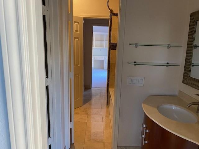 full bath featuring a bathing tub, tile patterned flooring, and vanity