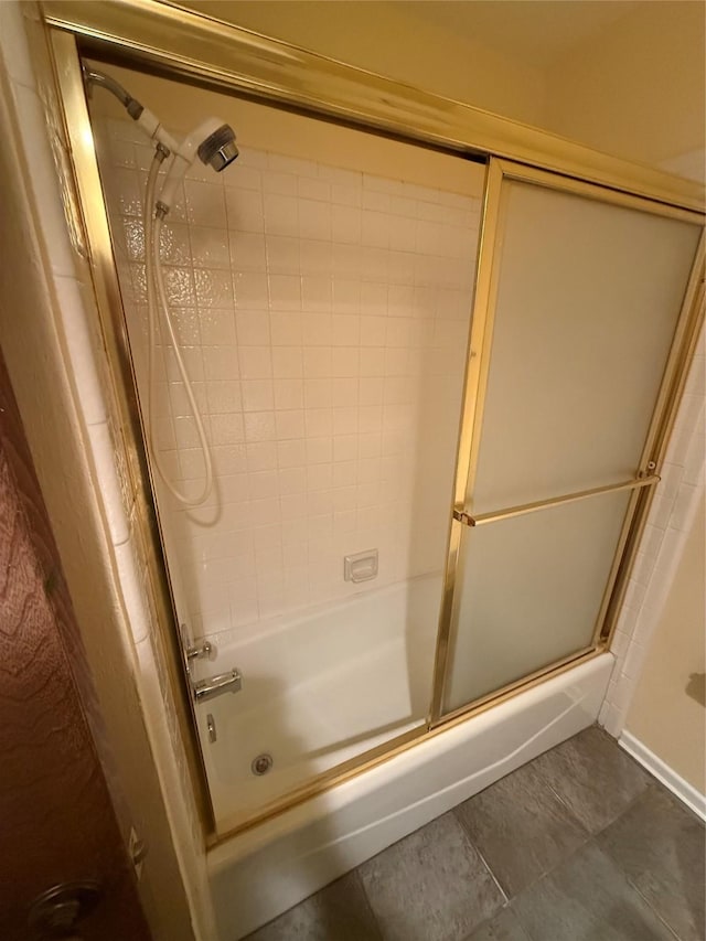 full bathroom with bath / shower combo with glass door