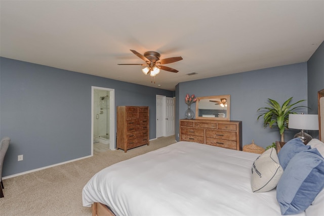 bedroom with carpet, a ceiling fan, ensuite bathroom, visible vents, and baseboards