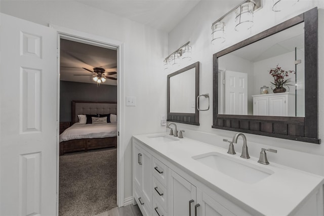 ensuite bathroom featuring a sink, ceiling fan, double vanity, and ensuite bathroom