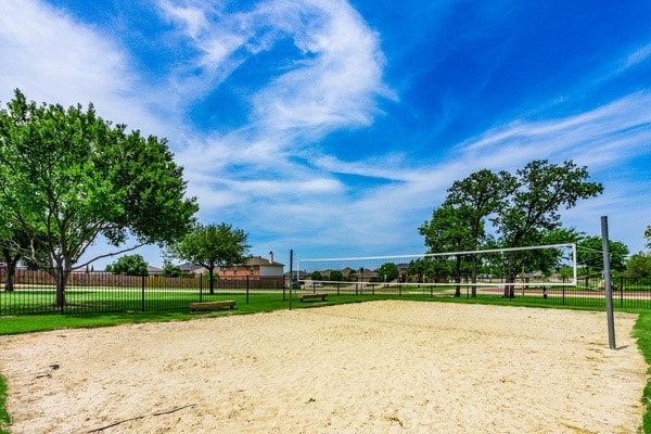 surrounding community featuring volleyball court and fence