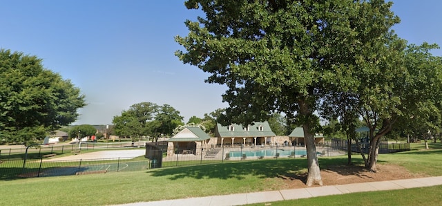 view of home's community featuring a yard and fence