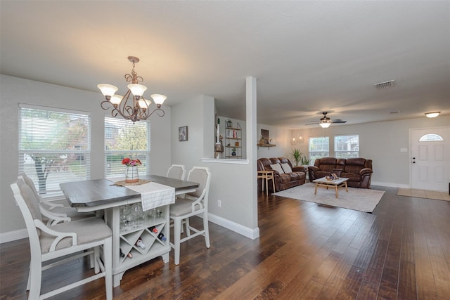 dining space featuring wood finished floors, visible vents, and baseboards