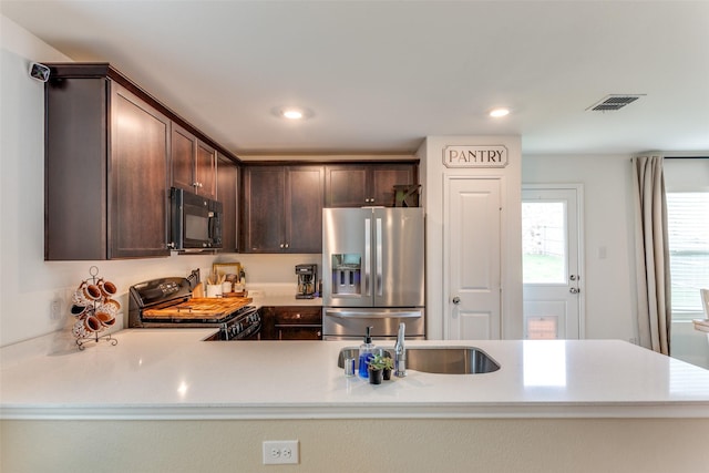 kitchen featuring visible vents, dark brown cabinetry, recessed lighting, light countertops, and black appliances