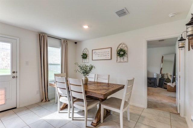 dining area featuring baseboards, plenty of natural light, light tile patterned flooring, and visible vents