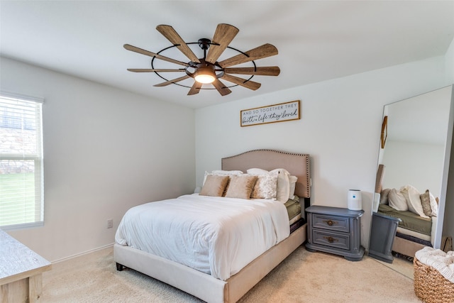 bedroom with ceiling fan and light carpet