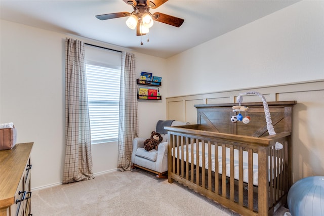 carpeted bedroom featuring baseboards and ceiling fan