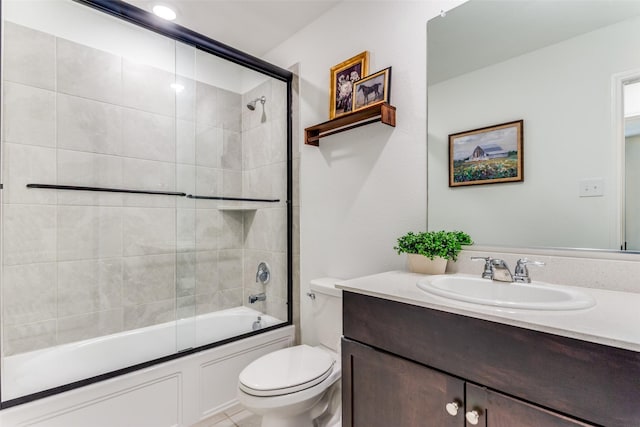 bathroom with vanity, bath / shower combo with glass door, and toilet