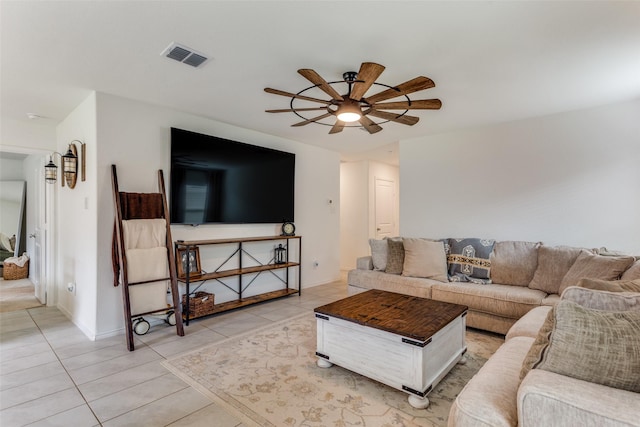 living room with light tile patterned floors, baseboards, a ceiling fan, and visible vents