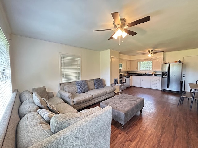 living area with a ceiling fan and dark wood-style flooring