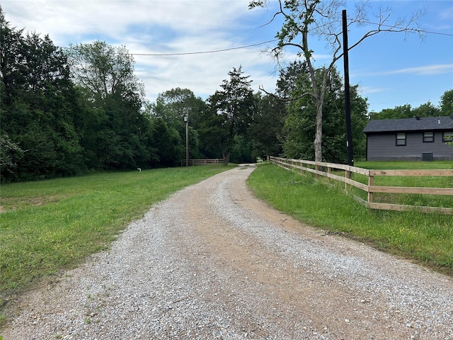 view of road featuring a forest view