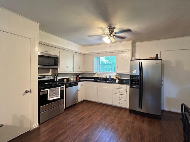 kitchen featuring dark countertops, appliances with stainless steel finishes, a ceiling fan, and dark wood-style floors