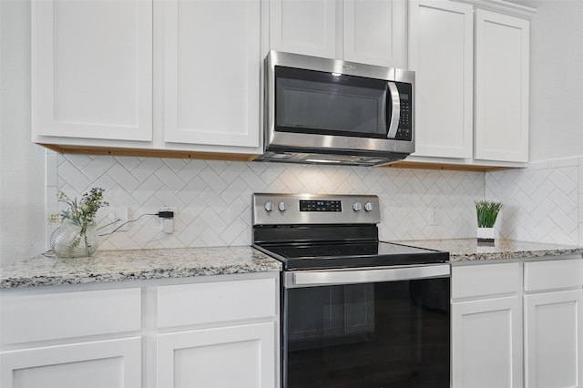 901 Cherry Blossom St, Anna, TX 75409 - kitchen with appliances with stainless steel finishes, tasteful backsplash, light stone countertops, and white cabinets