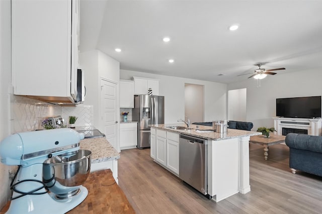 901 Cherry Blossom St, Anna, TX 75409 - kitchen with ceiling fan, a sink, open floor plan, stainless steel appliances, and light wood-style flooring