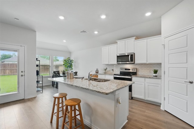 901 Cherry Blossom St, Anna, TX 75409 - kitchen with a sink, stainless steel appliances, tasteful backsplash, visible vents, and a center island with sink
