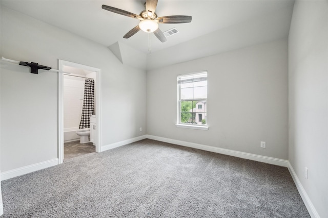 unfurnished bedroom featuring visible vents, baseboards, carpet, and lofted ceiling