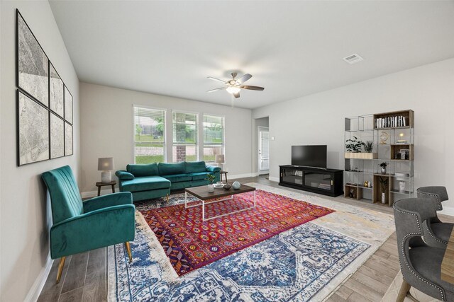 2900 Inn Kitchen Way, Mckinney, TX 75071 - living area with a ceiling fan, baseboards, and wood finished floors