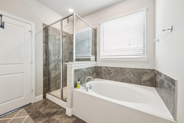 bathroom featuring a garden tub and a stall shower