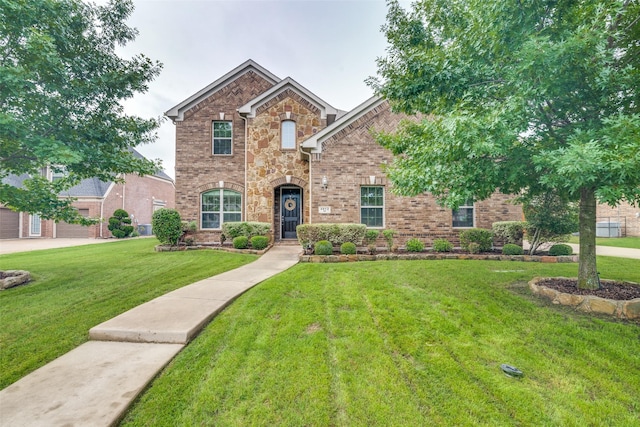 traditional home with brick siding, a front lawn, and stone siding