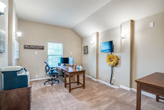 office space featuring baseboards, light colored carpet, and lofted ceiling