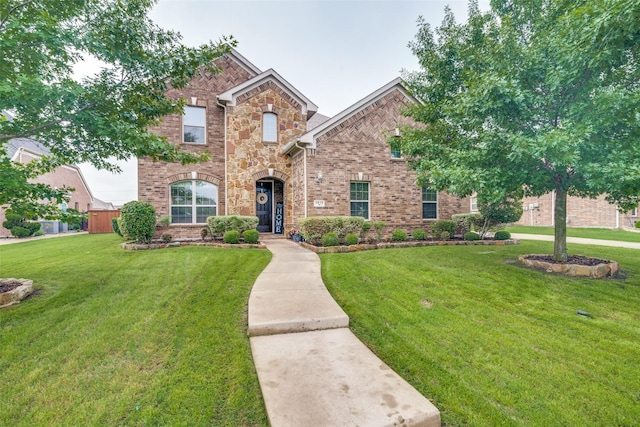 traditional-style home with brick siding and a front yard