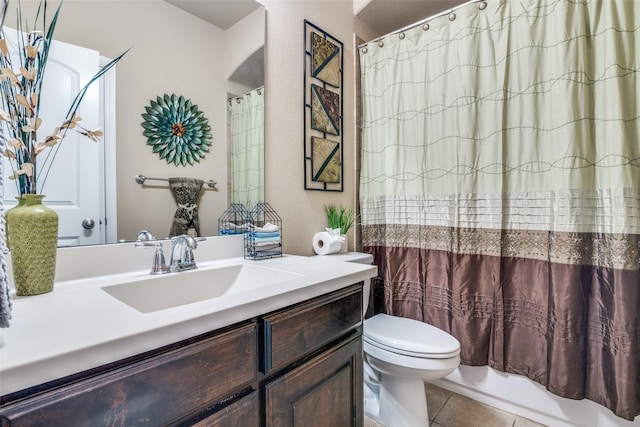 bathroom featuring vanity, tile patterned flooring, and toilet