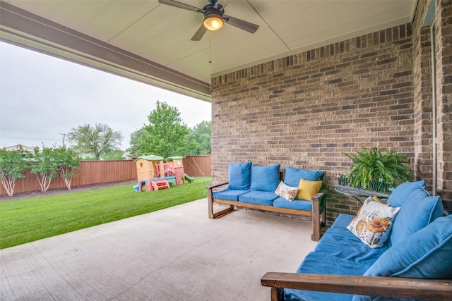 view of patio / terrace with an outdoor structure, a fenced backyard, a shed, an outdoor hangout area, and a ceiling fan