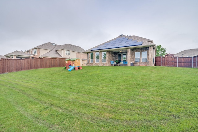 view of yard featuring ceiling fan, a fenced backyard, a playground, and a patio area