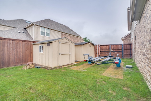view of yard with a storage unit, a fenced backyard, and an outdoor structure