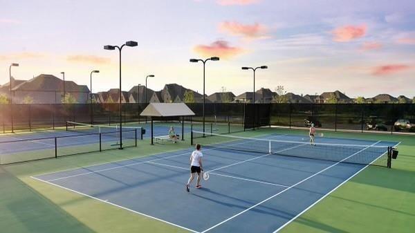 view of tennis court featuring fence, community basketball court, and a residential view